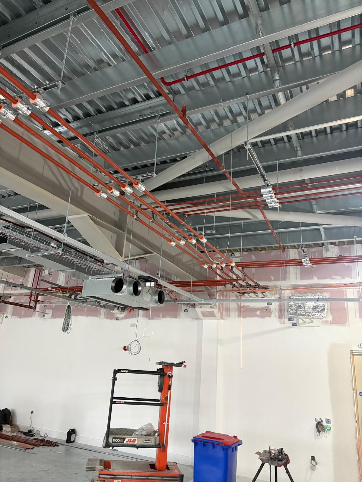Insulated copper pipework with ceiling-mounted fan coil unit